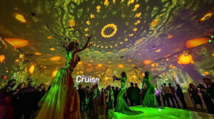 Immersive event entertainment in South Florida with live performers and projection lighting transforming the venue into an interactive visual experience by Aura Entertainment