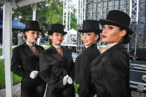 Professional lighting and live performers preparing backstage for a South Florida event production by Aura Entertainment
