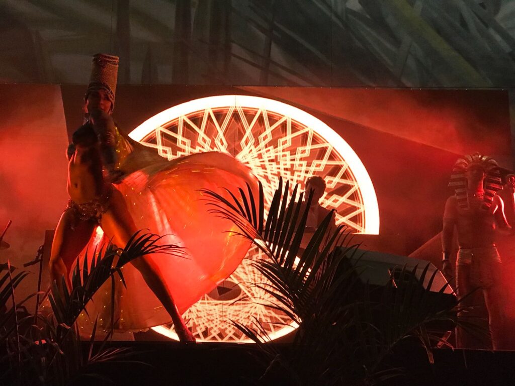 Alt Text: Event entertainment featuring theatrical dancers performing in front of a dramatic illuminated stage display at a South Florida event