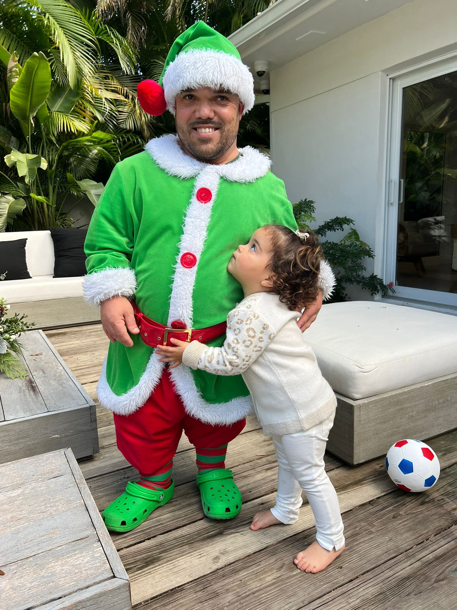 Holiday event featuring a festive elf performer interacting with a young child during a family friendly holiday event hosted by Aura Entertainment in South Florida