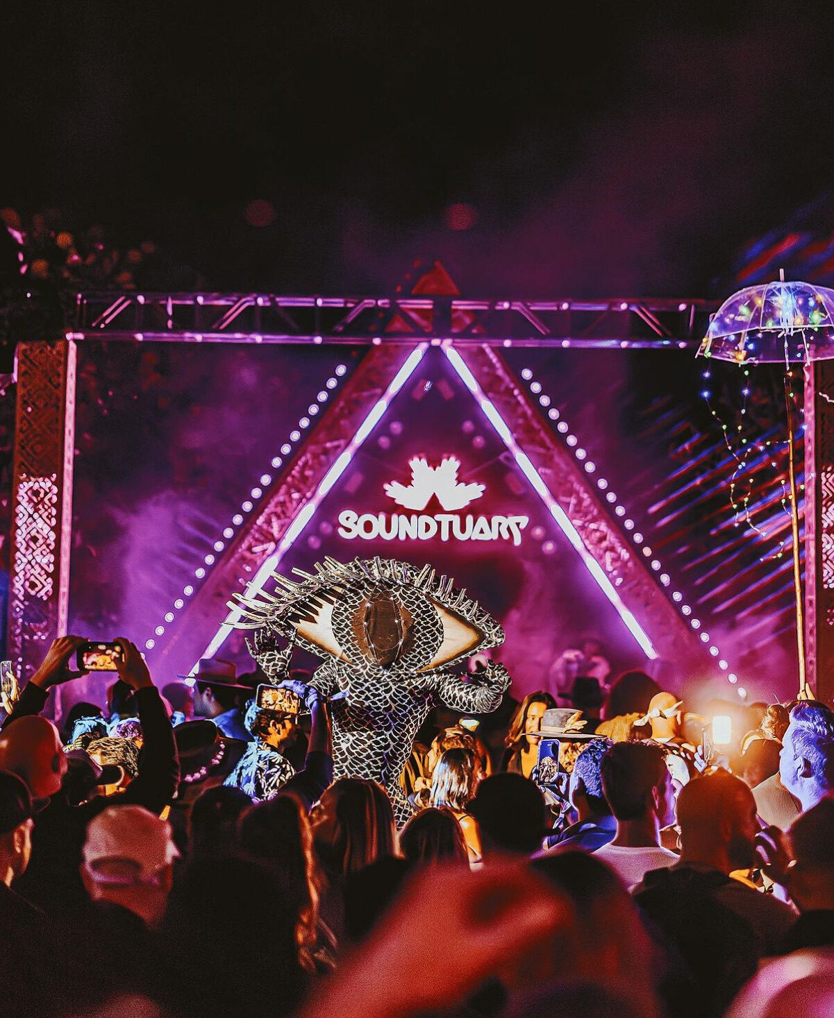 Large crowd at a South Florida event enjoying immersive event entertainment with a live stage performance and interactive performer engaging the audience